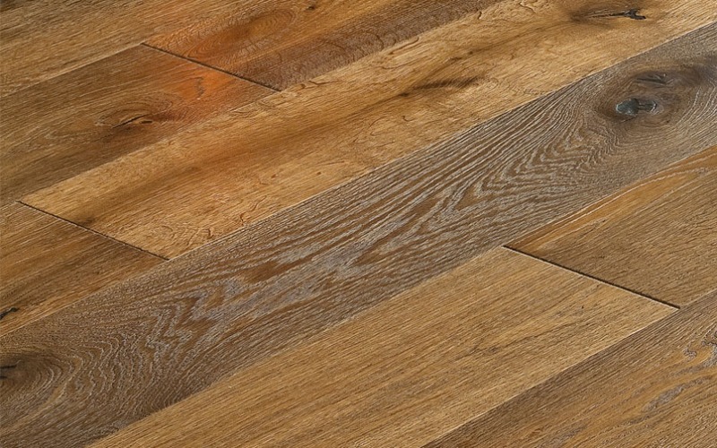 Closeup of a rich brown wood panel floor with wooden grooves and texture