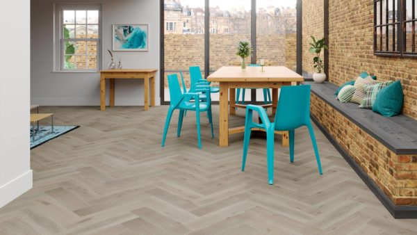 Dinning area with aqua blue plastic chairs, a wood table, and W-patterned light gray floors