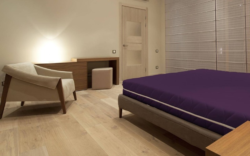 Sand beige colored bedroom with a purple mattress